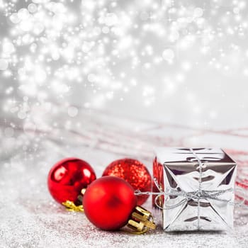Christmas balls and ornaments in front of glittering background