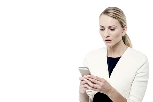 Surprised woman, looking at her mobile phone