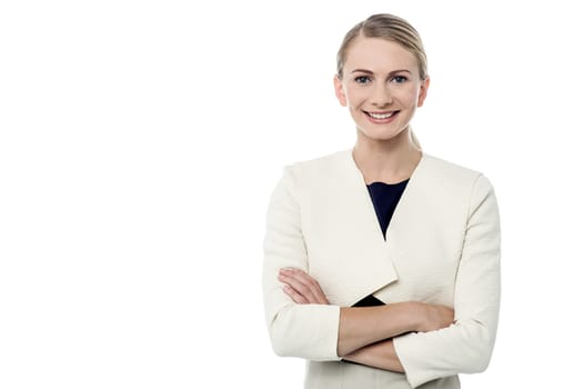 Young woman with folded arms looking into camera