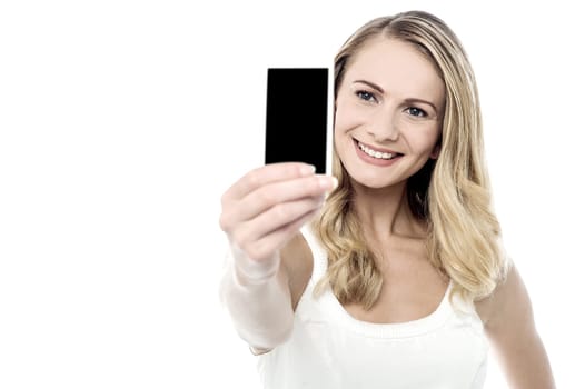 Happy young woman taking selfie over white background