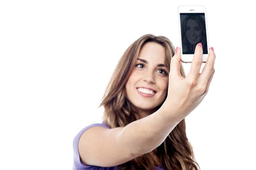Beautiful young taking selfie with her new phone