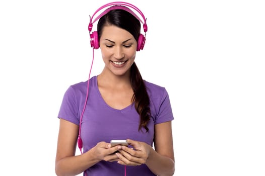 Pretty woman listening music on her head phone