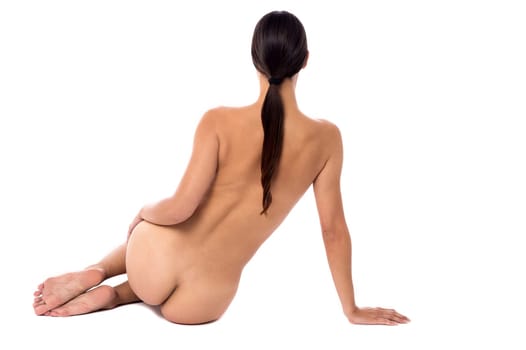 Back pose of a nude woman over white