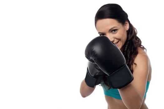 Sporty woman with posing to camera boxing gloves