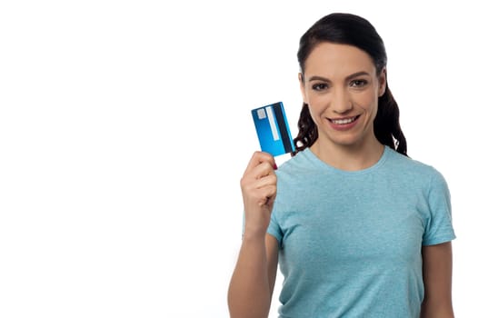 Pretty woman displaying her credit card over white