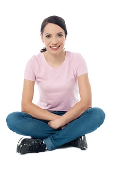 Happy young lady sitting with crossed legs