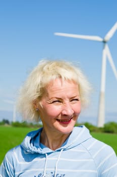 Portrait of a middle-aged woman on the background of wind-driven generators