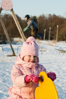 Children swinging on a swing in winter
