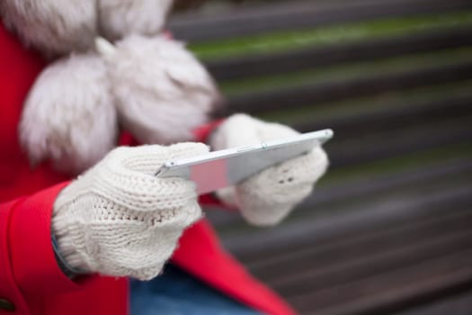 Traveling woman with mobile phone, cold weather