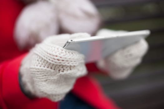Traveling woman with mobile phone, cold weather