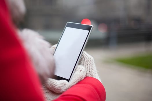 Traveling woman with mobile phone, cold weather