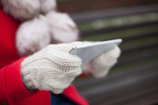 Traveling woman with mobile phone, cold weather