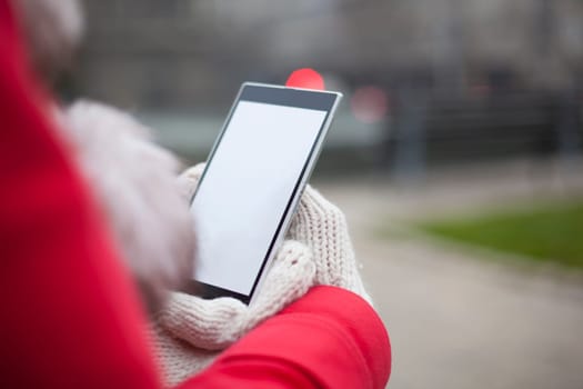 Traveling woman with mobile phone, cold weather