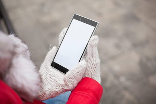 Traveling woman with mobile phone, cold weather
