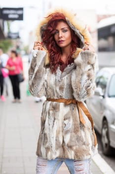 Beautiful Redhair Woman, Fashion Model In Artificial Fur Coat, Outdoor On Street Walking