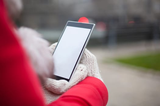 Traveling woman with mobile phone, cold weather