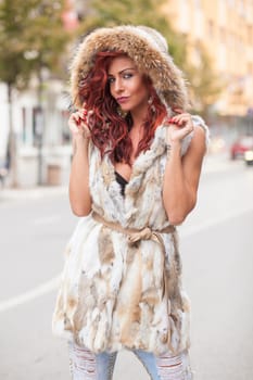 Beautiful Redhair Woman, Fashion Model In Artificial Fur Coat, Outdoor On Street Walking