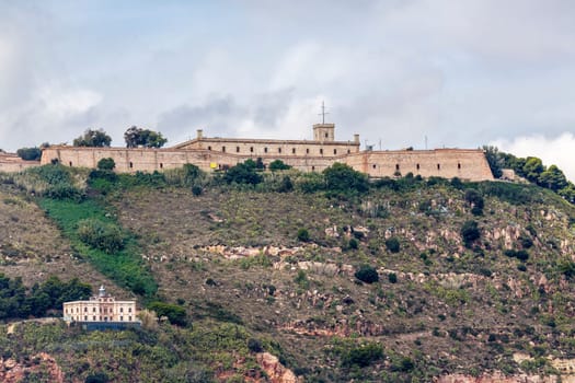 View of Castillo de Montjuic and lighthouse on mountain Montjuic in Barcelona, Spain
