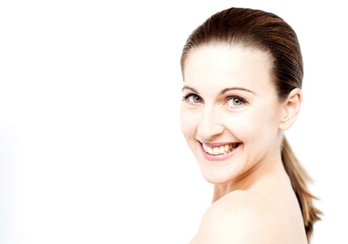 Smiling woman posing over shoulders to camera