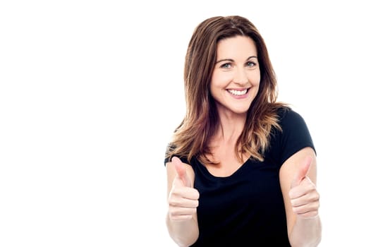 Cheerful lady showing thumbs up sign towards camera