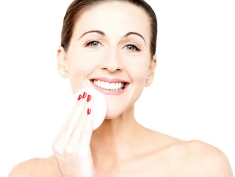 Beautiful woman cleaning her face with cotton after removing her make over