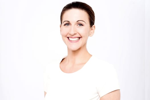 Half length image of a smiling beautiful woman posing in style
