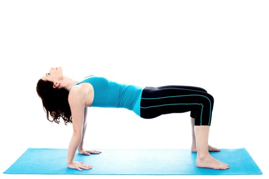 Pretty young woman doing exercises on the mat