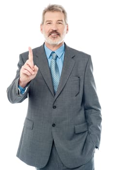Aged boss showing index finger over white