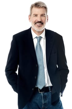 Image of a elder businessman with his hands in pockets