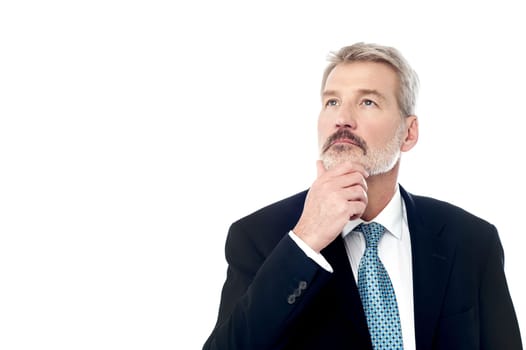Image of a senior man lost in business thoughts