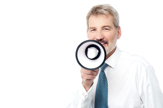 Senior business executive talking on a loudhailer