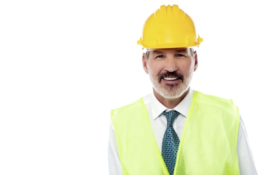 Senior construction engineer posing against white background