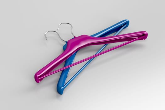 Purple and blue coat hangers on gray background
