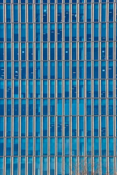 Close up cropped shot of skyscraper window frames in blue metal.