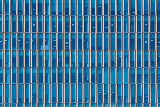 Close up cropped shot of skyscraper window frames in blue metal.