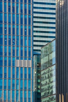 Close up cropped shot of skyscraper window frames in blue metal.