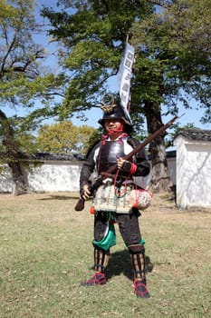 KAGAWA, JAPAN - OCTOBER 25: Ancient firelock rifle fighters at Marugame Historical battle Festival, event dedicated to Japanese culture and tradition at Marugame-castle on October 25, 2015 in Japan.