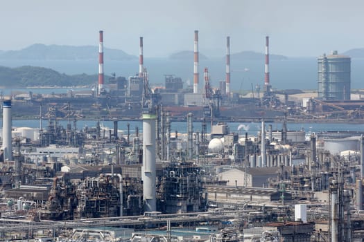 refinery plant with smoke stacks, industrial site