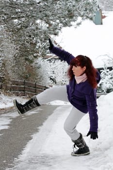 Risk of accidents in winter - A woman slips on a snow-smooth road