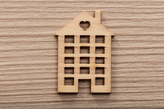 little wooden house with an heart on a wooden background ideal as background or wallpaper