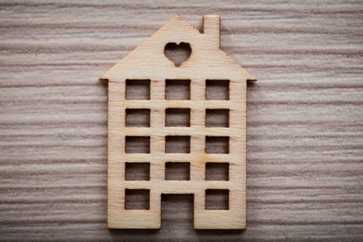 little wooden house with an heart on a wooden background ideal as background or wallpaper