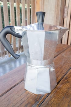 Italian coffee maker on wooden table, stock photo