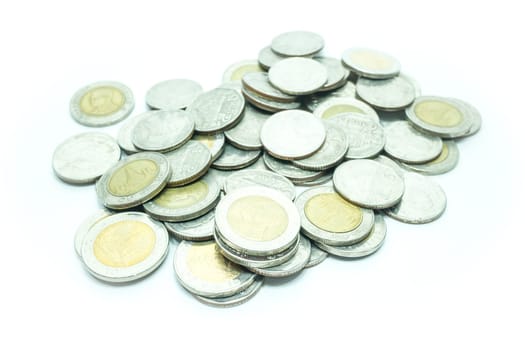 Group of Thai baht coins on white table background, stock photo