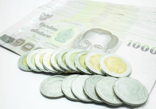 Thai banknote and coin on white background, stock photo