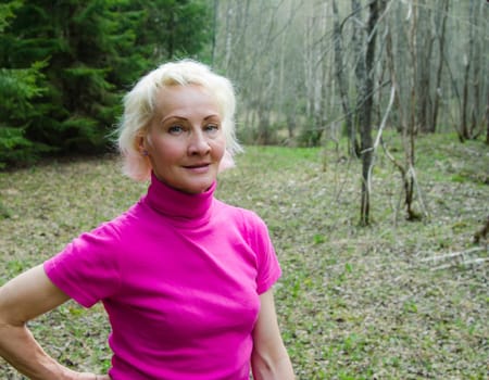 Portrait of a middle-aged woman in a park on a sunny day