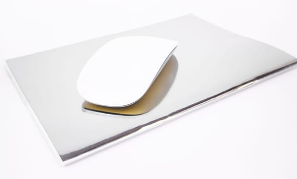 Wireless mouse top note book isolated on white background, stock photo