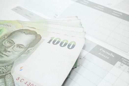 Thai money banknote on record table note book, stock photo