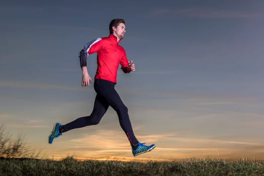 jogger on the horizon in front of clear sky