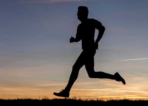 silhouette of a jogger at sunset