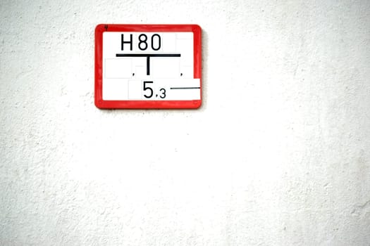 A nostalgic sign for water pipes on a prominent concrete wall.